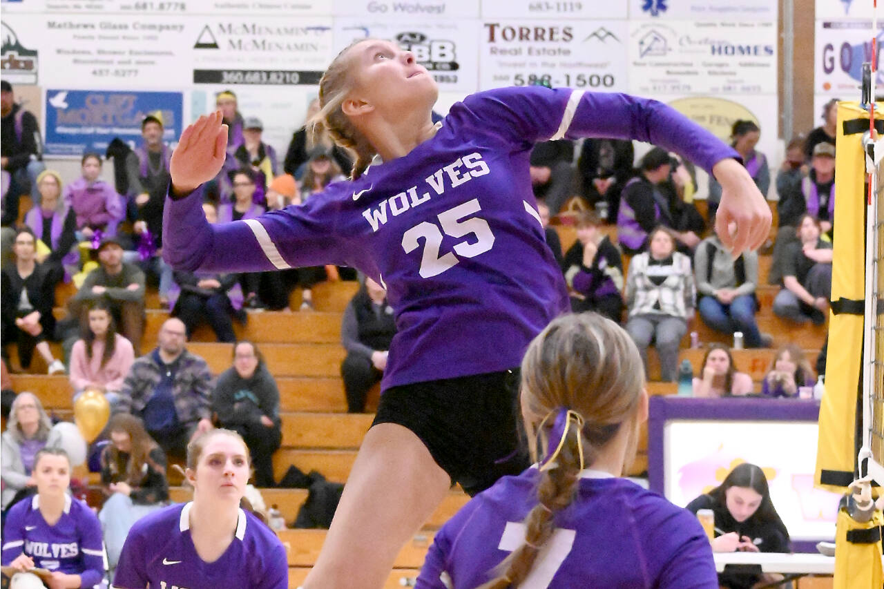 Sequim’s Jolene Vaara (25) spikes against Bremerton on Tuesday with teammate Arianna Stovall (33) waiting for a possible return. (Michael Dashiell/Olympic Peninsula News Group)
