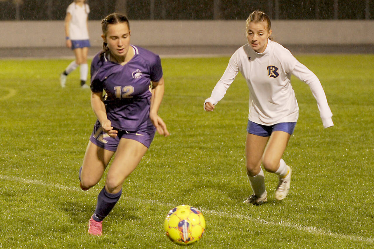 Sequim’s Olive Bridge, left, grabs possession of the ball and looks for a teammate in the first half of a 6-0 home win Tuesday over Bremerton. (Michael Dashiell/Olympic Peninsula News Group)