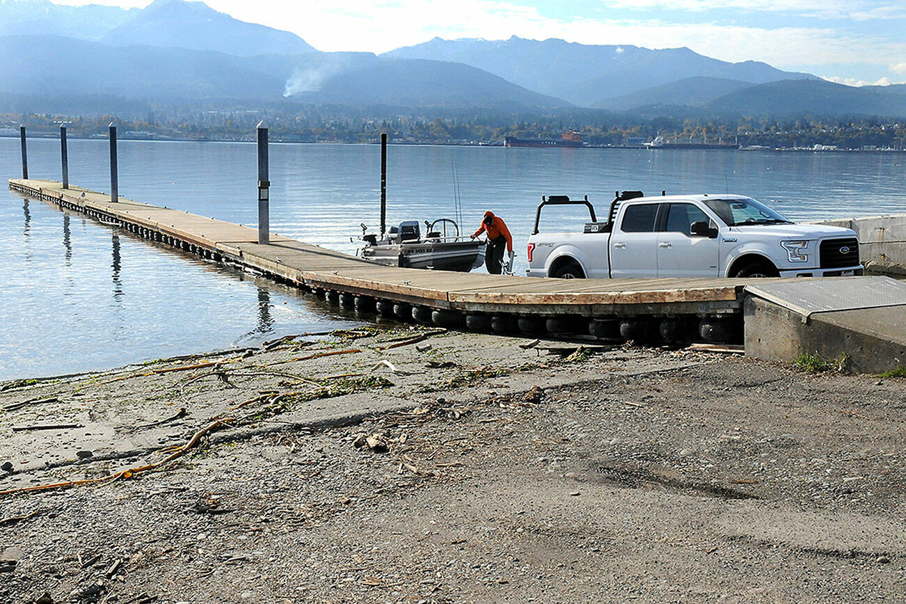 Kyle Kautzman of Sequim loads a boat onto a trailer at the boat launch on Ediz Hook on Thursday. The City of Port Angeles removed a second floating dock at the launch to protect it from adverse weather because repair parts are no longer available. (Keith Thorpe/Peninsula Daily News)