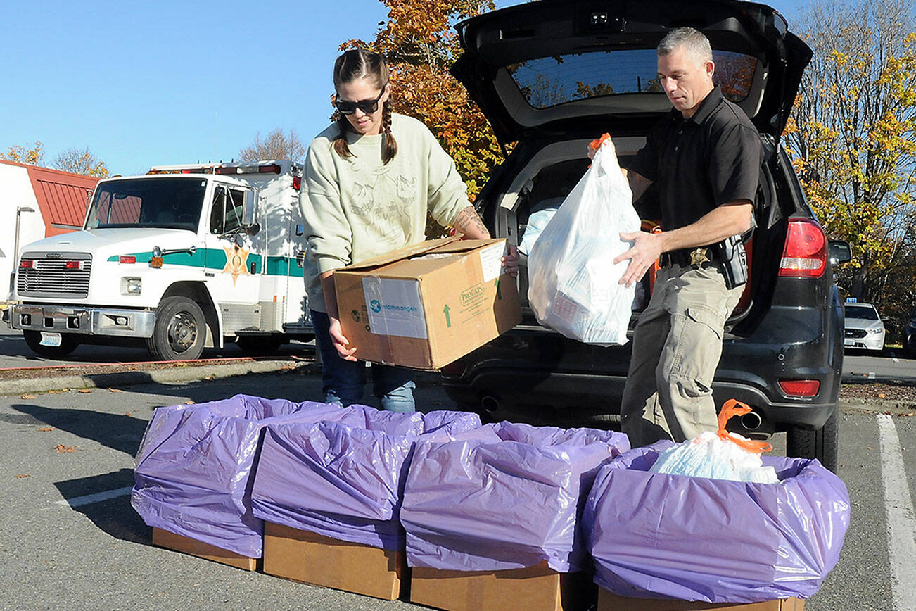 Helen Kenoyer of the Olympic Peninsula Community Clinic and Inspector Josh Ley of the Clallam County Sheriffs Office unload unwanted pharmaceuticals and medications from the agency at a drop-off point at the Clallam County Courthouse during Saturday’s National Prescription Drug Take Back Day. At the event, people were allowed to get rid of unwanted or expired drugs for disposal in a safe and responsible manner. Additional drop-off points on Saturday were at Sequim City Hall and the QFC grocery store in Port Hadlock. Year-round drug disposal sites are kiosks at the Clallam County Sheriff’s Office in Port Angeles, at the Sequim Police Department and through the Jefferson County Sheriff’s Office in Port Hadlock. (Keith Thorpe/Peninsula Daily News)