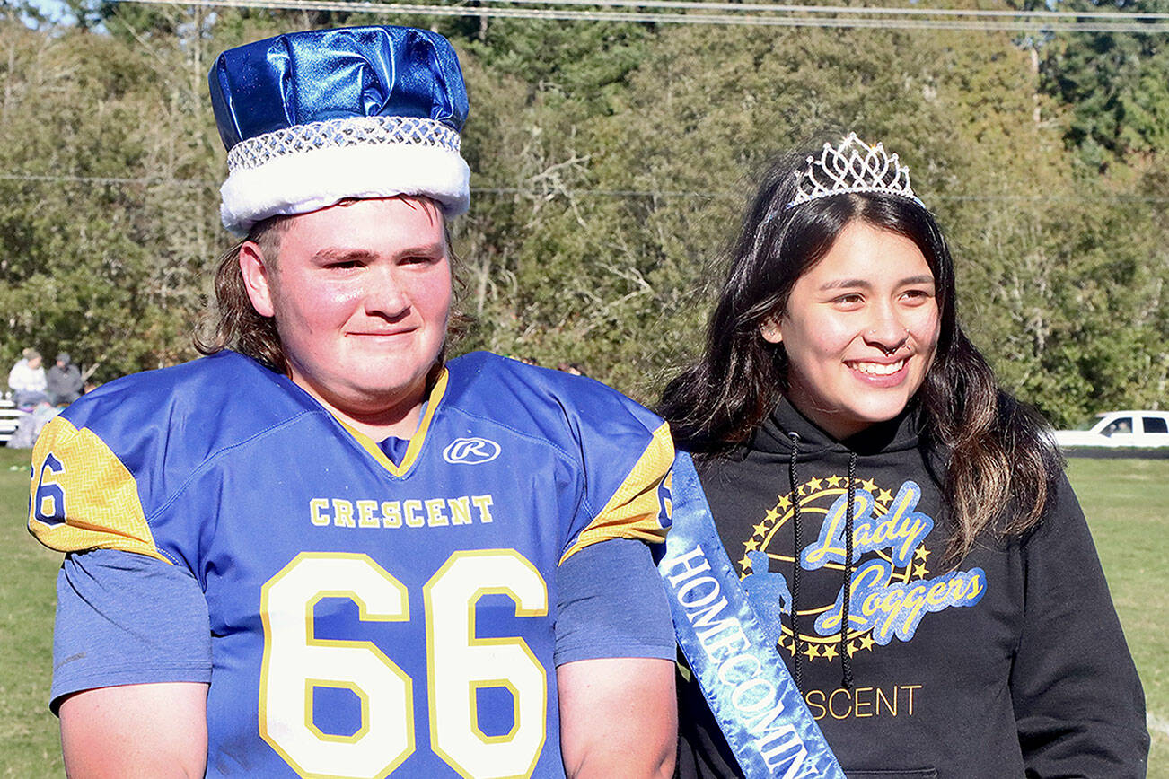 King Wyatt Owens, a lineman for the Crescent High School football team, left, and Queen Ciara Cargo were named homecoming royalty at halftime of the Loggers’ game against Darrington on Saturday. Both are seniors at the school. (Dave Logan/for Peninsula Daily News)