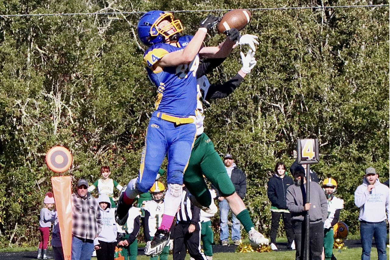 Crescent's Carter Clifford hauls in a pass under the tight defense of a Darrington player Saturday in Joyce. (Dave Logan/for Peninsula Daily News)