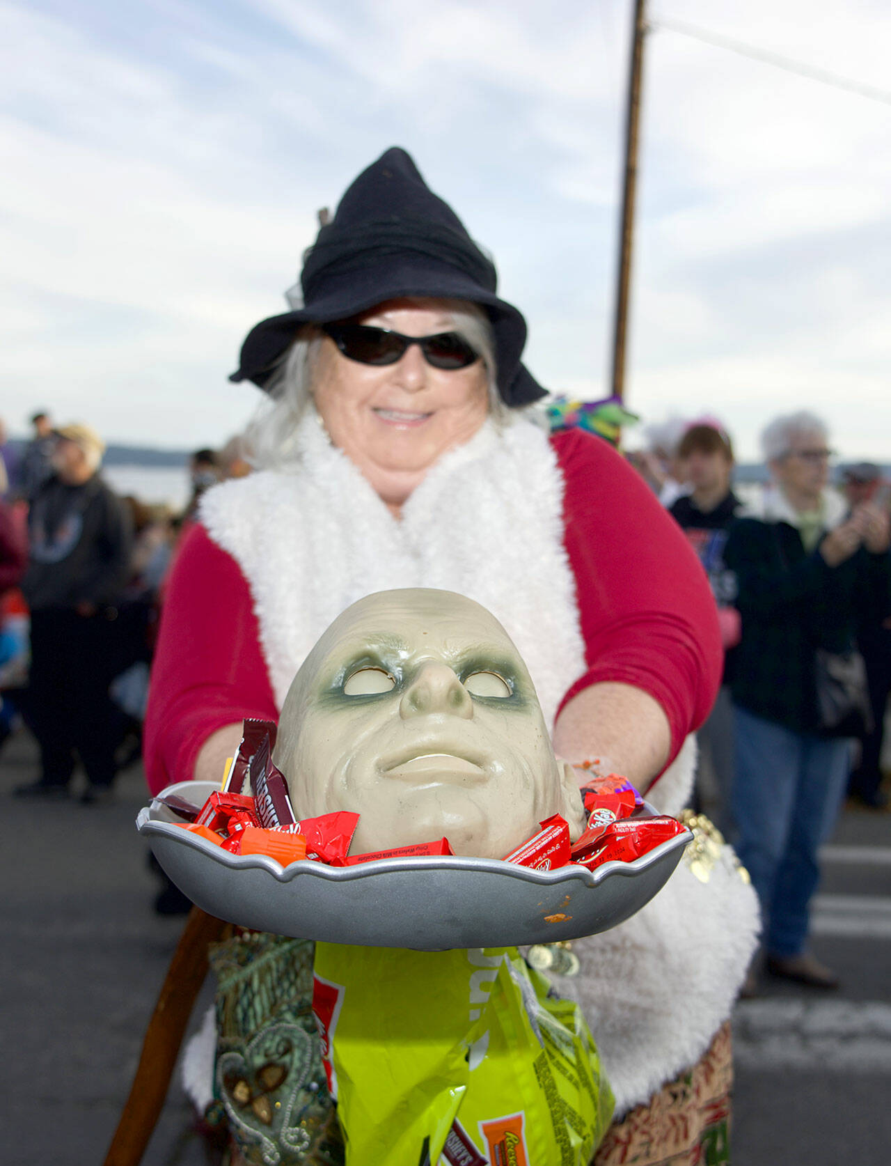 Druze Hartwell of Port Townsend holds a bowl with a mask in the middle before marching in the 27th Port Townsend Main Street Program Trick or Treat and Costume Parade in downtown Port Townsend on Tuesday. (Steve Mullensky/for Peninsula Daily News)