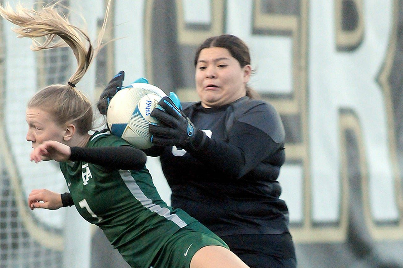 KEITH THORPE/PENINSULA DAILY NEWS
Port Angeles' Izzy Felton, front, gets tangled in the box with Renton goalkeeper Zitlaly Valeriano-Reyes during Tuesday's bidistrict playoff at Wally Sigmar Field in Port Angeles.