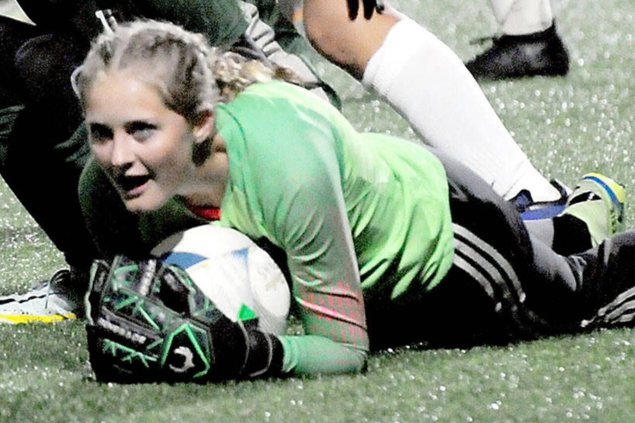 Sequim goalkeeper Kalli Grove, here stopping a goal against Port Angeles in October, stopped two penalty kicks in a bidistrict playoff win Tuesday over Enumclaw to help send the Wolves to the state 2A tournament. (Keith Thorpe/Peninsula Daily News)