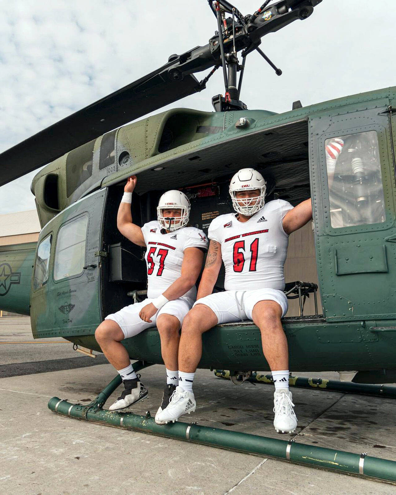 Eastern Washington Football Forks’ Luke Dahlgren, left, and offensive line teammate Wyatt Hansen are featured in the Eastern Washington football program’s uniform reveal ahead of today’s “White Out” home game against Cal Poly. The pair are pictured in a helicopter at Spokane’s Fairchild Air Force Base.