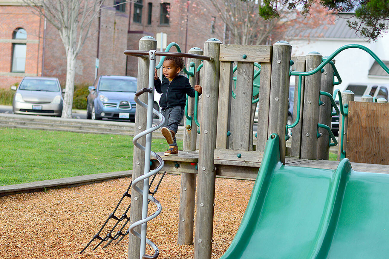 Liwane Senghor, 2 1/2, enjoys downtown Port Townsend’s playground despite the chilly wind. High temperatures are forecast to be in the upper 40s this week with rain showers likely. (Diane Urbani de la Paz/for Peninsula Daily News)