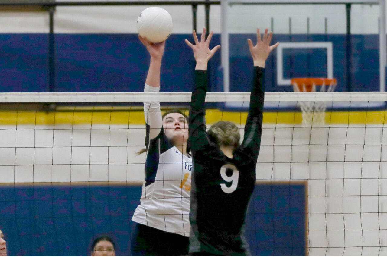 Forks' Kaidence Rigby tips the ball over a Napavine defender during the Spartans' loss against Napavine in the 2B District 4 Tournament on Saturday in Adna. (Dylan Wilhelm/The Chronicle)
