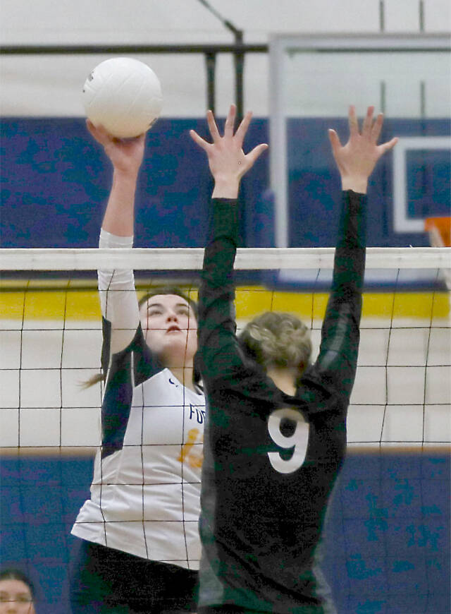 Forks’ Kaidence Rigby tips the ball over a Napavine defender during the Spartans’ loss against Napavine in the 2B District 4 Tournament on Saturday in Adna. (Dylan Wilhelm/The Chronicle)