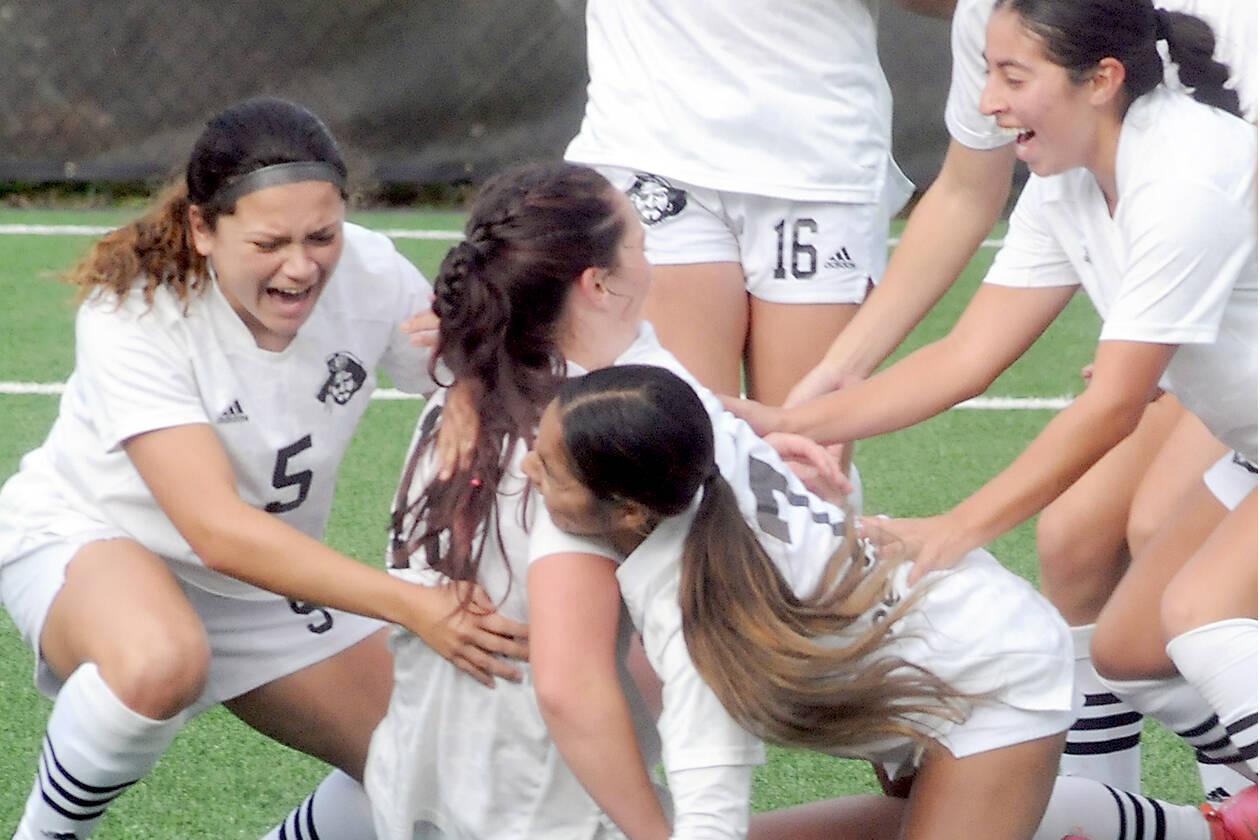 KEITH THORPE/PENINSULA DAILY NEWS
Peninsula's Eliana Barden, on ground, is dogpiled by her teammates, clockwise from left, Taya Bohenko, Shawna Larson, Sydney Soskis, Maylin Rivera and Caneel Corpuz after Barden fired off the winning goal in overtime to defeat the North Idaho Cardinals 1-0 in Saturday's NWAC quarter-final game in Port Angeles.