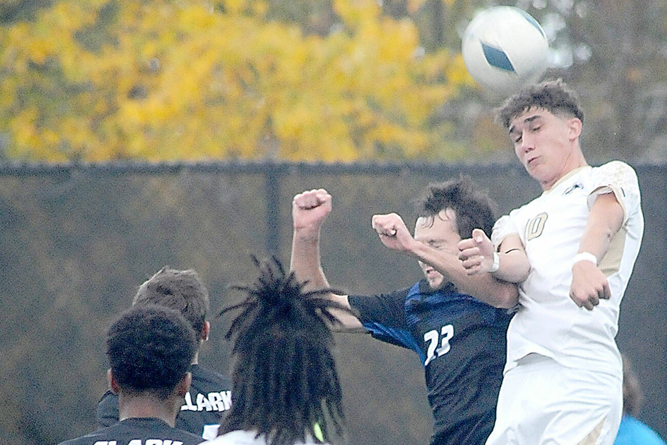 KEITH THORPE/PENINSULA DAILY NEWS
Peninsula's Nil Grau, right, takes the header over Clark's Wilson Fresh as Grau's teammate, Abdurahim Leigh, looks on at front during Saturday's match in Port Angeles.