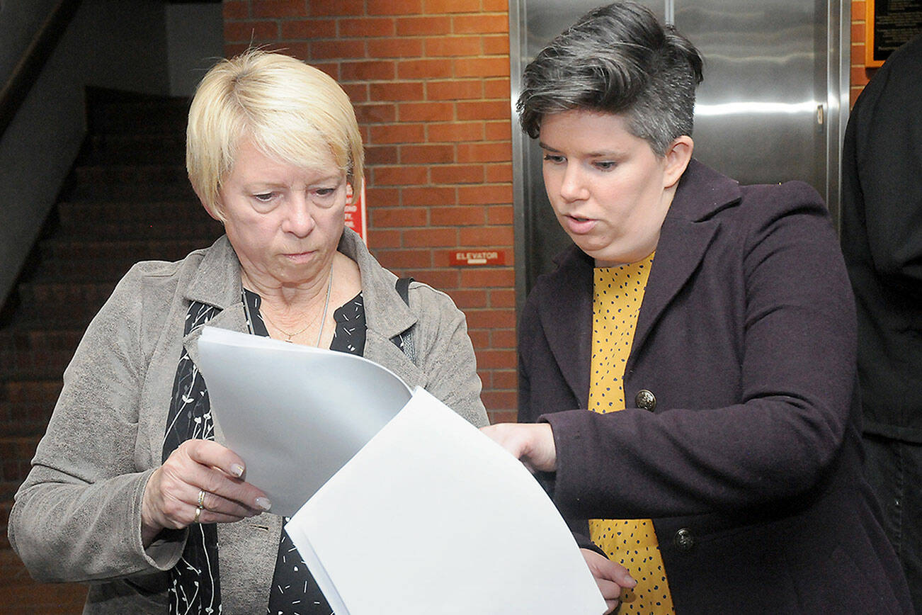 Port of Port Angeles incumbent Connie Beauvais, left, and incumbent Port Angeles City Council member Navarra Carr examine early election returns on Tuesday at the Clallam County Courthouse. (Keith Thorpe/Peninsula Daily News)