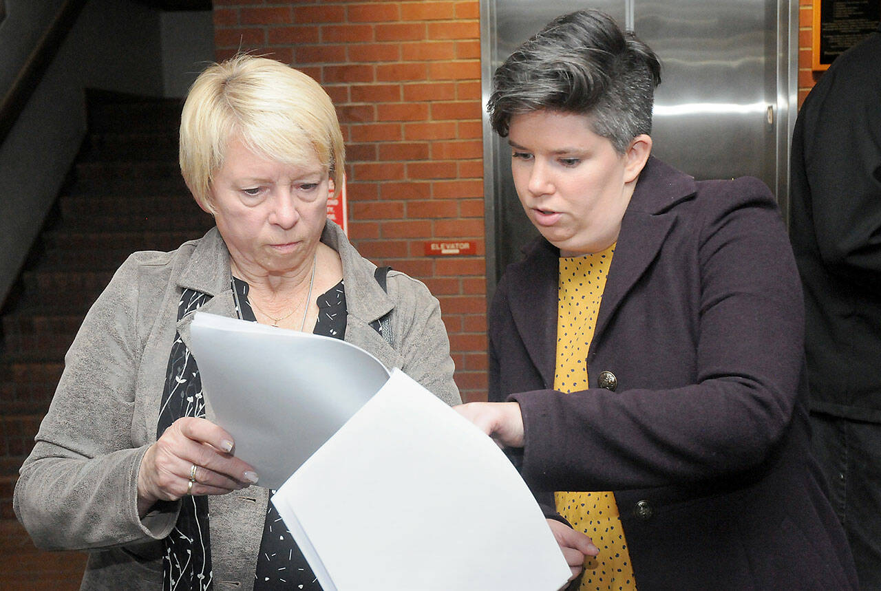 Port of Port Angeles incumbent Connie Beauvais, left, and incumbent Port Angeles City Council member Navarra Carr examine early election returns on Tuesday at the Clallam County Courthouse. (Keith Thorpe/Peninsula Daily News)