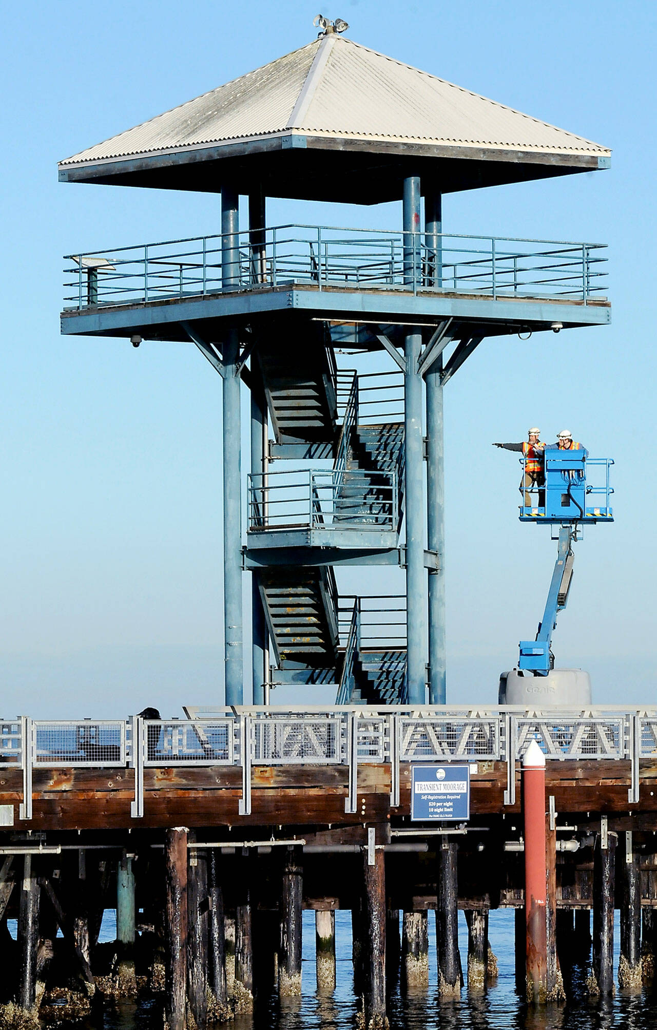 Craig Mallow, left, and Quinten Calquhoun of Olympia-based Sargent Engineers, Inc., use a lift to inspect the outside structure of the observation tower at the end of Port Angeles City Pier on Wednesday. (Keith Thorpe/Peninsula Daily News)