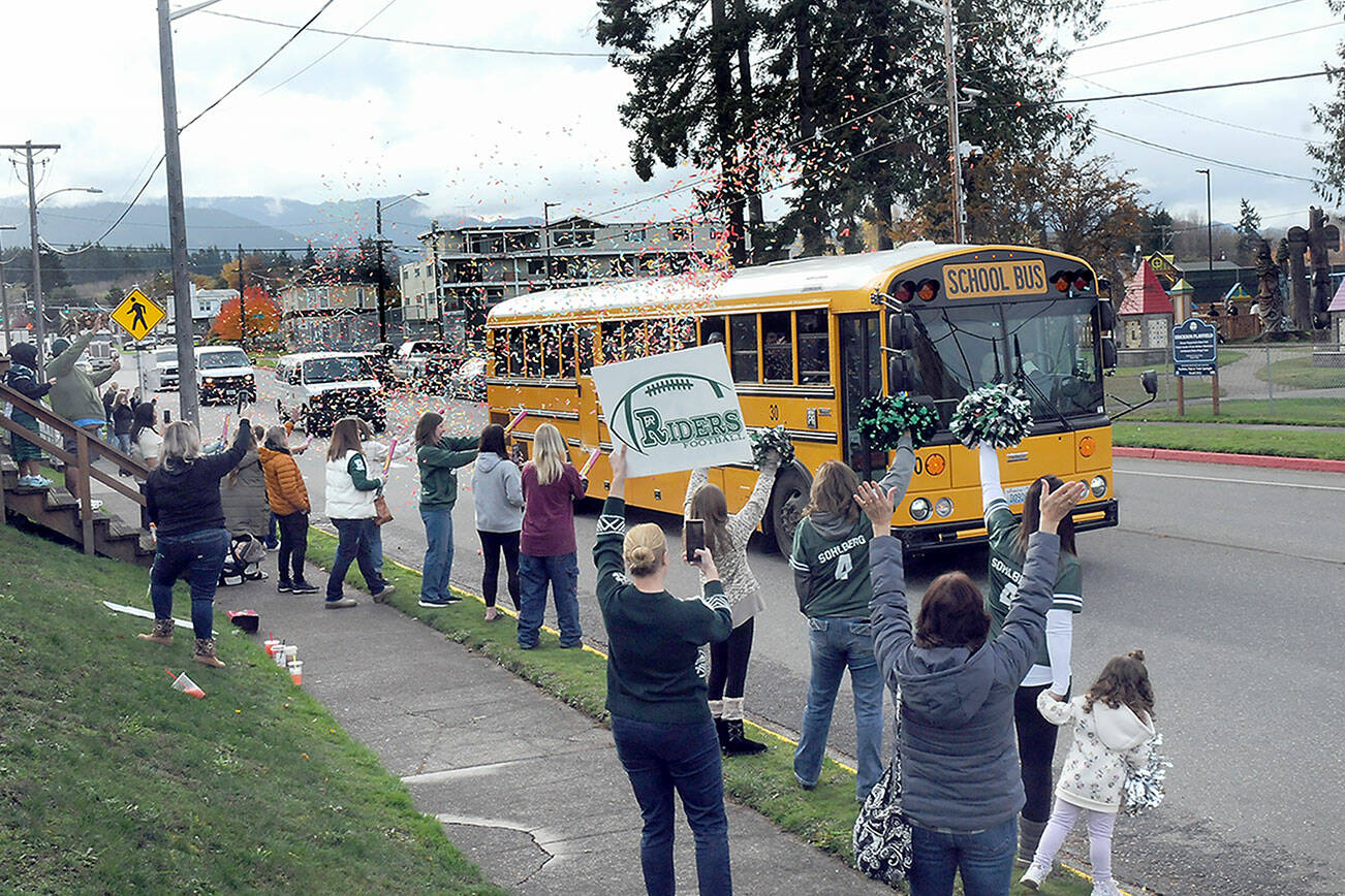 KEITH THORPE/PENINSULA DAILY NEWS
Friends, family and Roughrider fans line Race Street in front of Port Angeles Civic Field as a bus carrying the Port Angeles High School football team heads for Tumwater for Friday's state playoff opener. The Roughriders were on their first trip to state in more than a decade to play No. 1-seeded Tumwater High School. Dozens of people took part in the team sead-off.