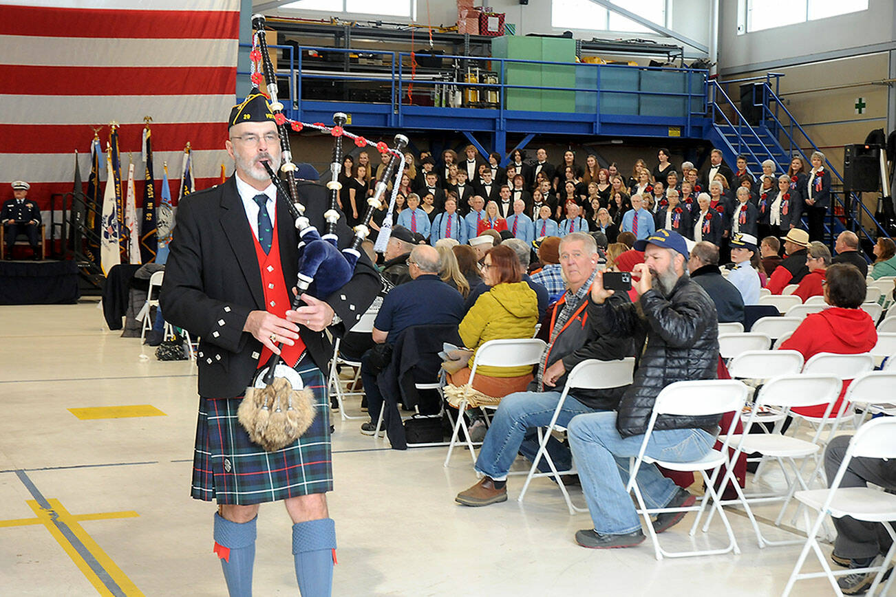 Bagpiper Rick McKenzie performs “Amazing Grace” to close Saturday’s Veterans Day ceremony in the hanger at U.S. Coast Guard Air Station/Sector Field Office Port Angeles. (Keith Thorpe/Peninsula Daily News)