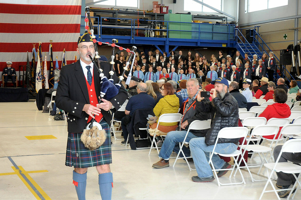 Bagpiper Rick McKenzie performs “Amazing Grace” to close Saturday’s Veterans Day ceremony in the hanger at U.S. Coast Guard Air Station/Sector Field Office Port Angeles. (Keith Thorpe/Peninsula Daily News)
