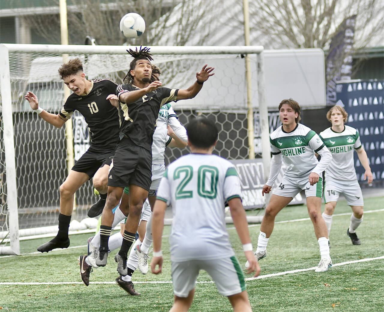 Peninsula College’s Nil Grau, left, and Abdurahim Leigh battle for a ball in front of the Highline net Sunday in Tukwila. (Jay Cline/Peninsula College)