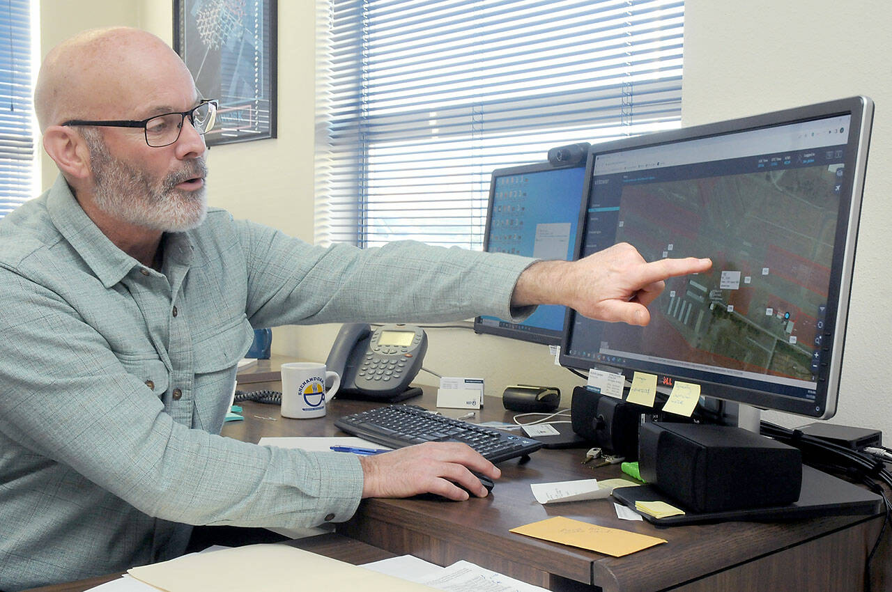 Willian R. Fairchild International Airport manager Jon Picker points out features of the airport’s Virtower airport tracking system during a demonstration on Friday. (Keith Thorpe/Peninsula Daily News)
