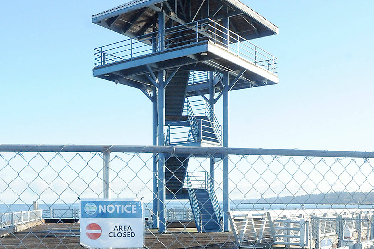 Temporary fencing blocks the end of Port Angeles City Pier at the observation tower after the city closed the area. (Keith Thorpe/Peninsula Daily News)