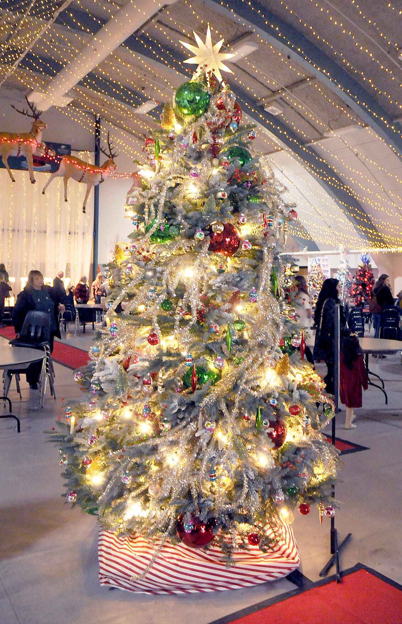 A decorated Christmas tree titled “Take Me Back” stands at Vern Burton Community Center in Port Angeles on Saturday after fetching the top bid of $7,500 offered by the Jamestown S’Klallam Tribe during Saturday night’s Festival of Trees gala auction. The tree, designed by Staci Politik and sponsored by Applebee’s Restaurant, included a $2,000 premium gift certificate for home furnishings from Angeles Furniture. More than 40 trees were auctioned off on Friday as a benefit for the Olympic Medical Center Foundation. (Keith Thorpe/Peninsula Daily News)