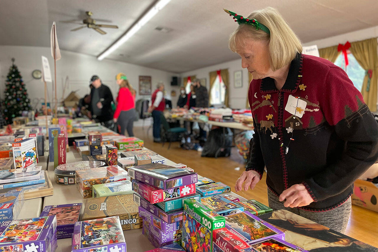 Volunteer Linda Richl organizes toys and games at Toys for Sequim Kids in Sequim Prairie Grange in 2022. This year’s event is set for Dec. 12 in the grange. (Matthew Nash/Olympic Peninsula News Group)