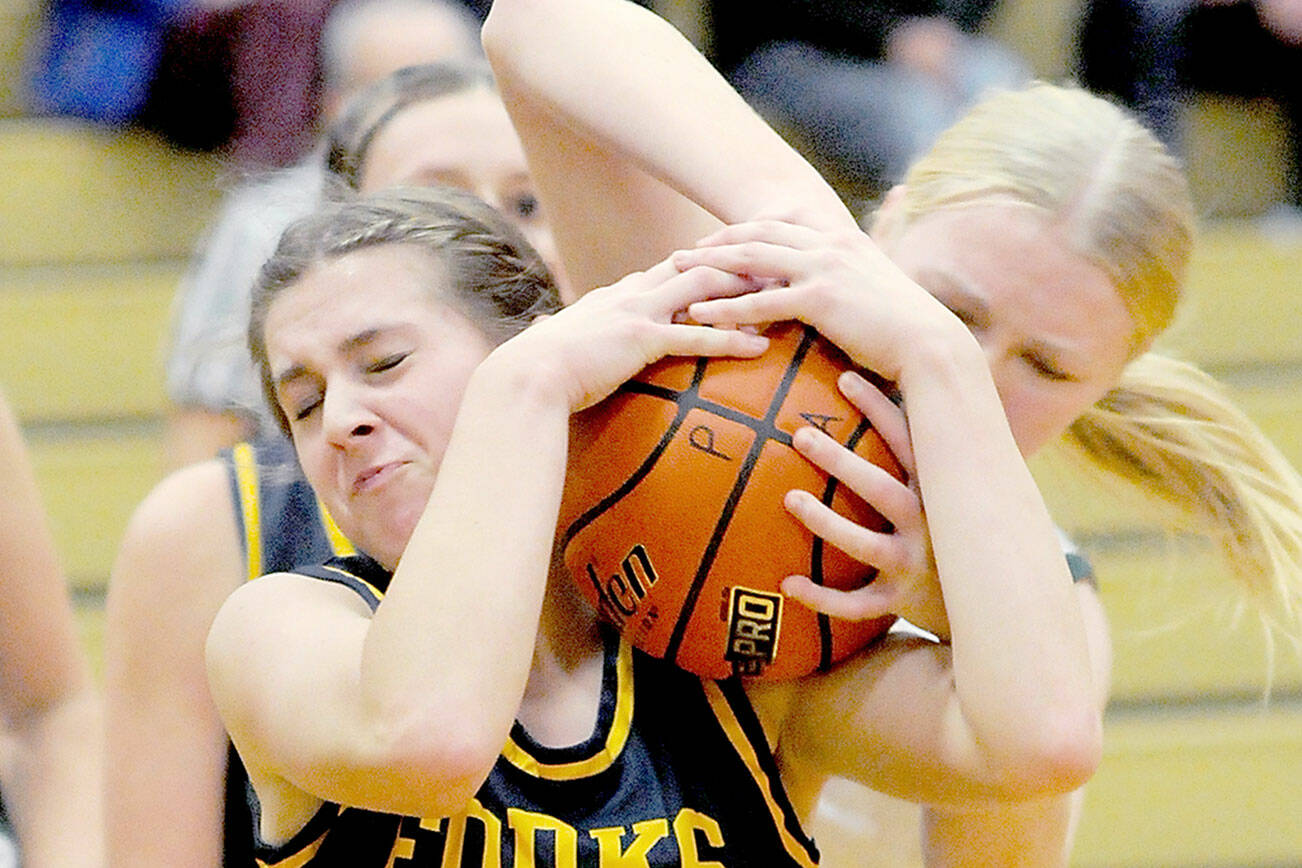 KEITH THORPE/PENINSULA DAILY NEWS
Forks' Chloe Gaydeski, front, battles for the ball with Port Angeles' Paige Mason during Tueday's game at Port Angeles High School.