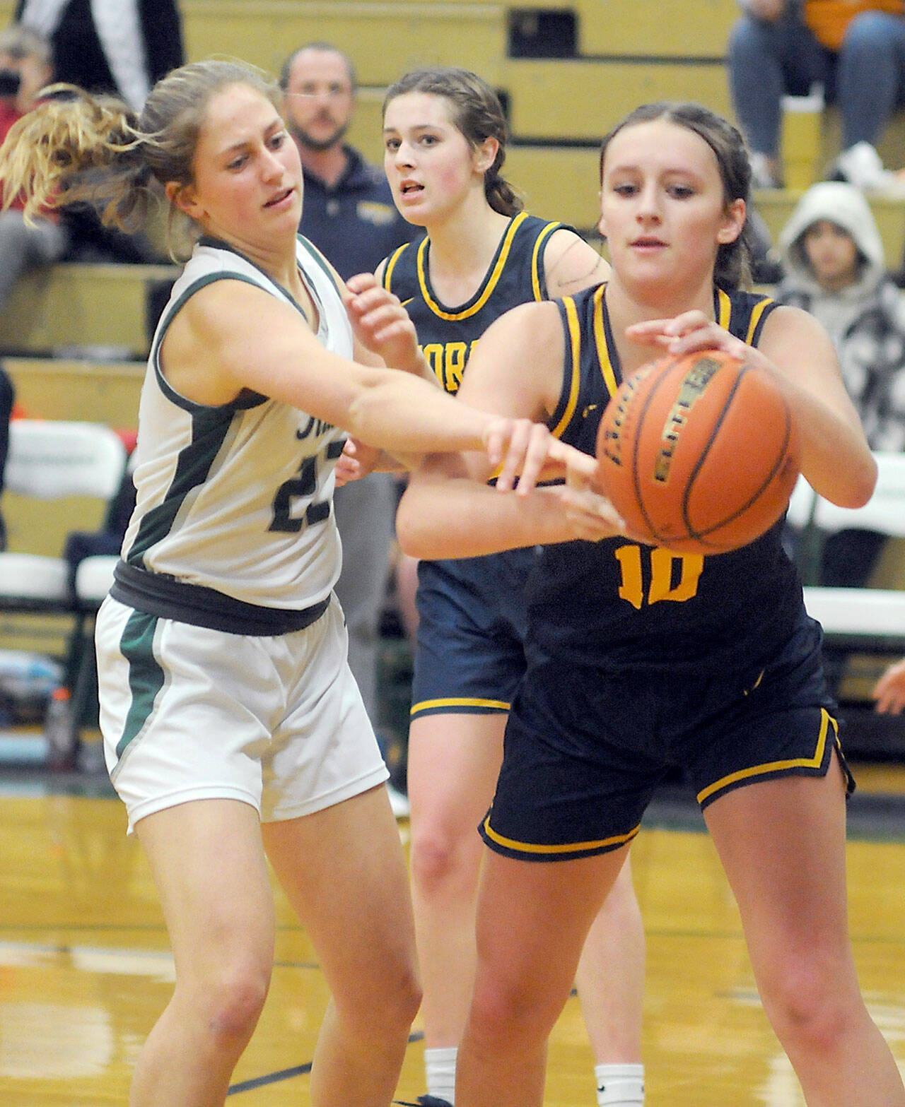 KEITH THORPE/PENINSULA DAILY NEWS Forks’ Avery Dilley, right, pulls down a rebound ahead of Port Angeles’ Becca Manson on Tuesday in Port Angeles.