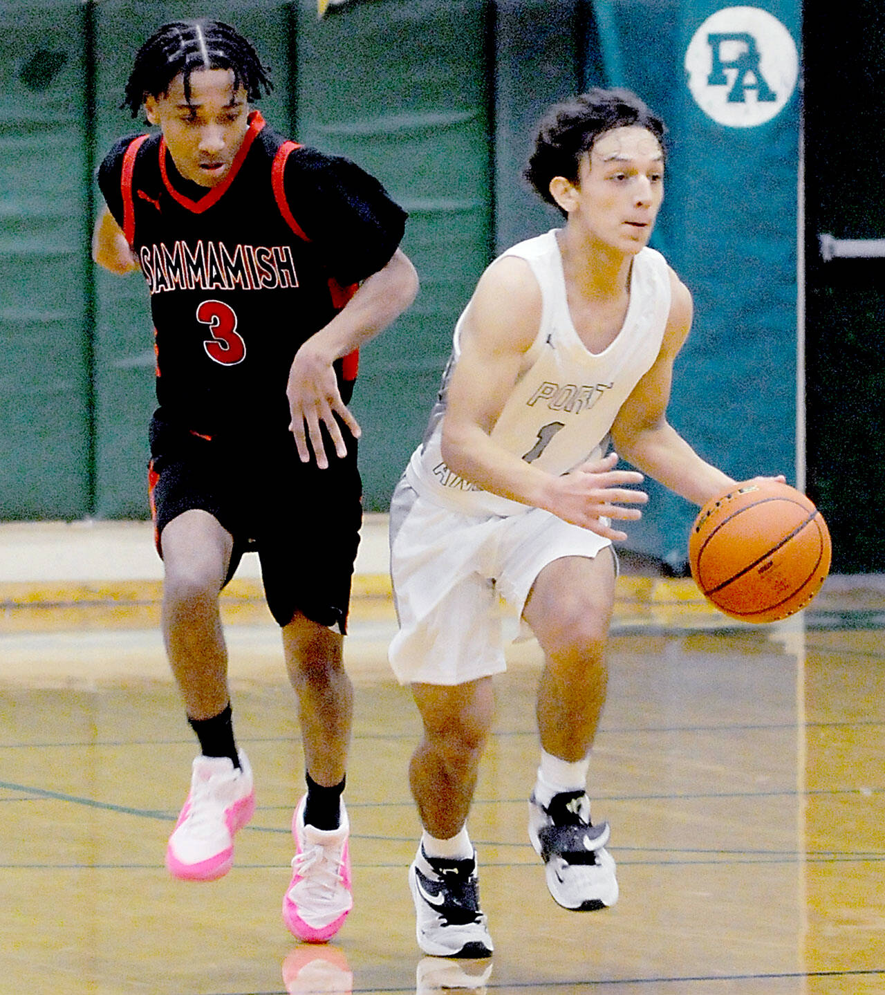 Port Angeles’ Kason Albaugh, right, moves the ball as Sammamish’s Anthony Boddie follows along on Wednesday at Port Angeles High School. (Keith Thorpe/Peninsula Daily News)