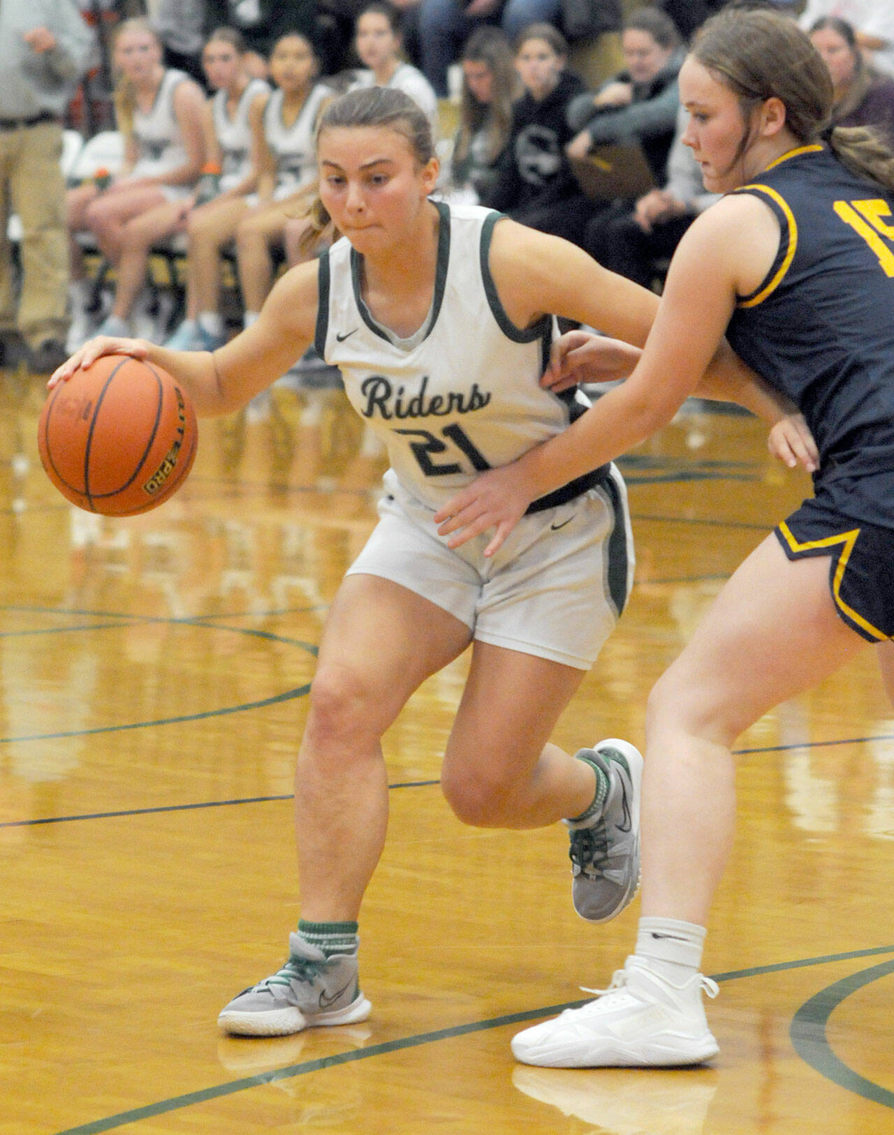 KEITH THORPE/PENINSULA DAILY NEWS Port Angeles’ Kennedy Rognlien, left, slips around Forks’ Fynlie Peters on Tuesday night at Port Angeles High School.