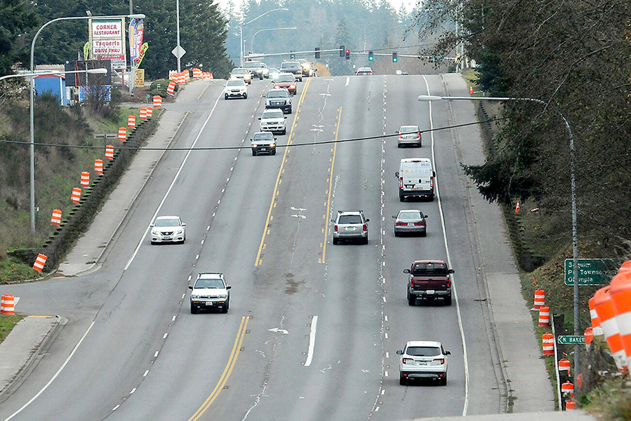 Orange traffic barrels line the sides of U.S. Highway 101 at Ennis Creek for preliminary surveys in preparation for upcoming culvert replacement. (Keith Thorpe/Peninsula Daily News)