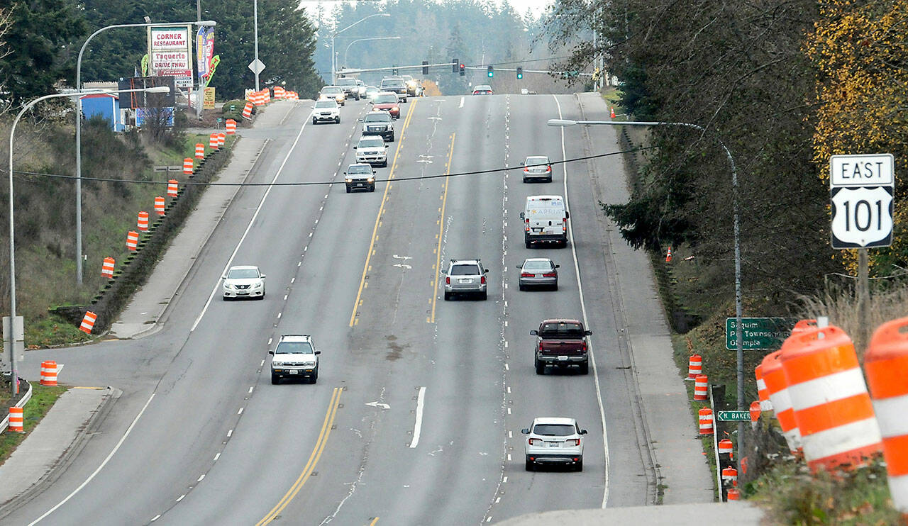 Orange traffic barrels line the sides of U.S. Highway 101 at Ennis Creek for preliminary surveys in preparation for upcoming culvert replacement. (Keith Thorpe/Peninsula Daily News)