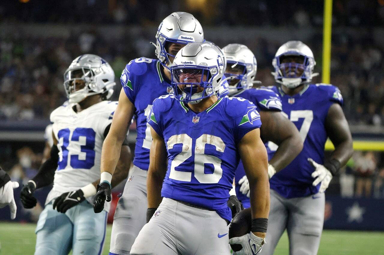 Seattle Seahawks running back Zach Charbonnet (26) celebrates after running the ball for a long gain in the second half of an NFL football game against the Dallas Cowboys in Arlington, Texas on Thursday. (Michael Ainsworth/The Associated Press)