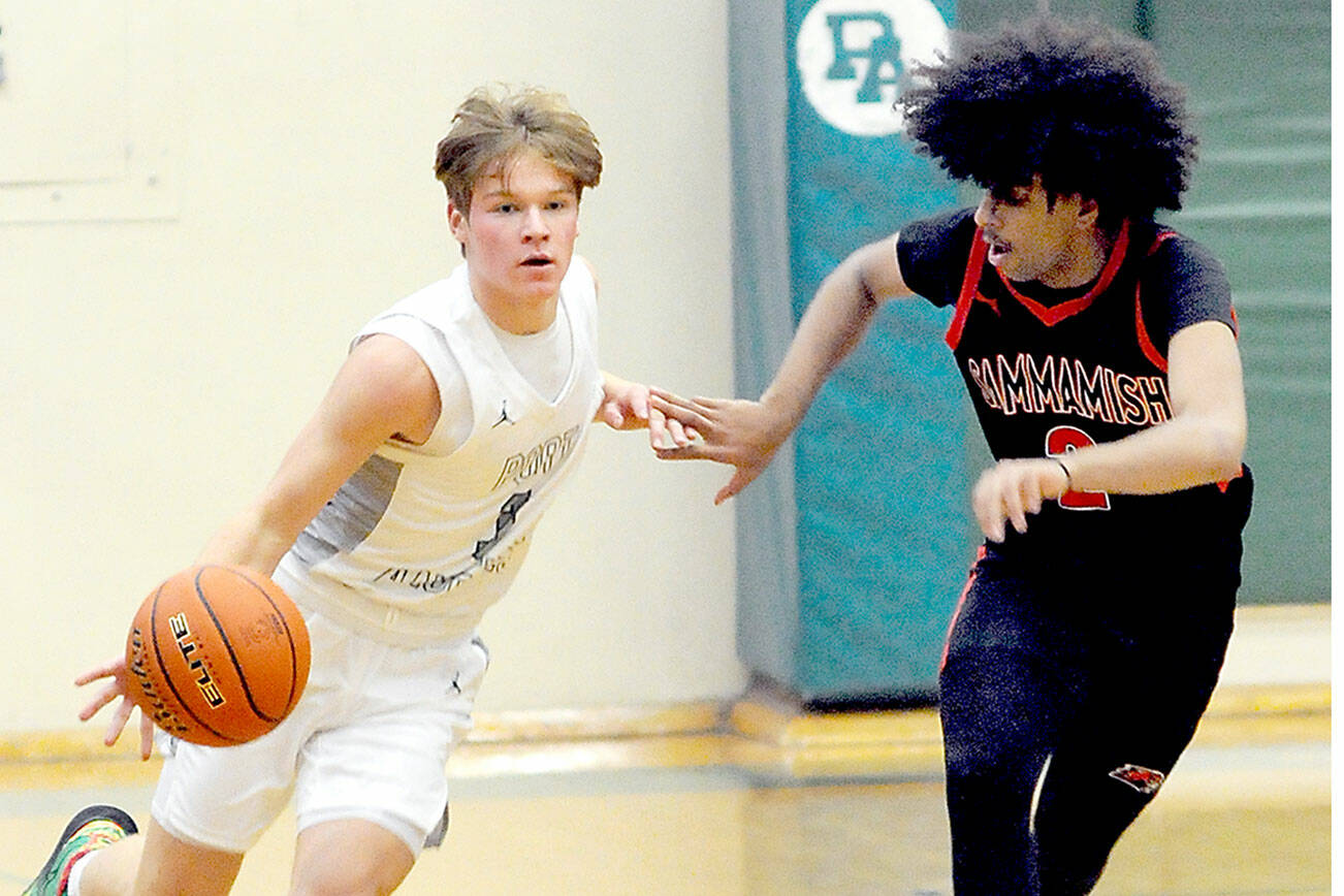 Port Angeles’ Gus Halberg, left, drives down court paced by Sammamish’s Rakin Showki on Wednesday night in Port Angeles. Halberg is expected to be a big contributor this year for the Roughriders. (Keith Thorpe/Peninsula Daily News)