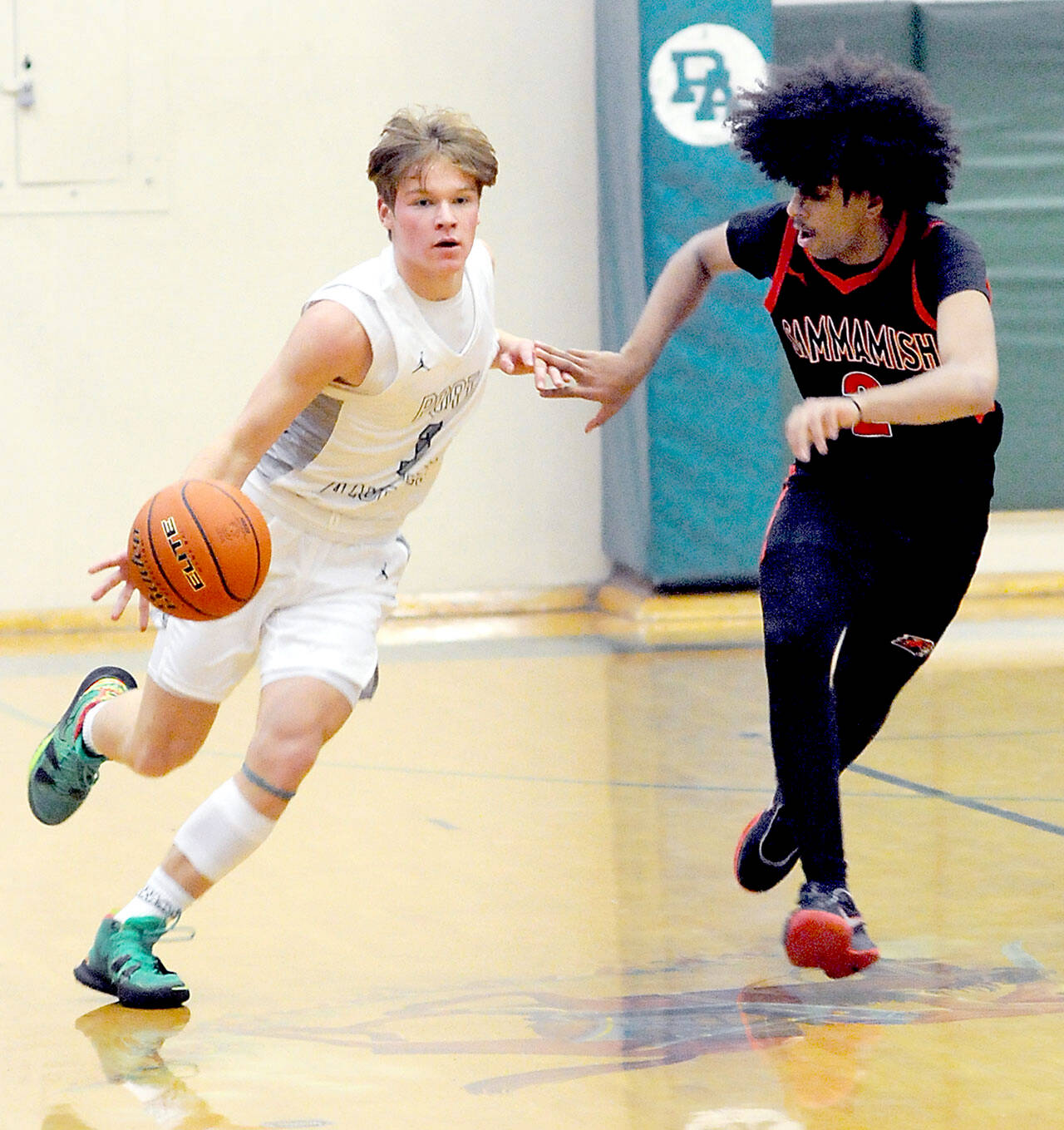 Port Angeles’ Gus Halberg, left, drives down court paced by Sammamish’s Rakin Showki on Wednesday night in Port Angeles. Halberg is expected to be a big contributor this year for the Roughriders. (Keith Thorpe/Peninsula Daily News)