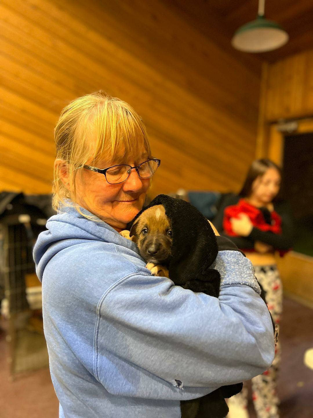 Kathy Coakley of Welfare for Animals Guild comforts one of the feral puppies caught on the Hoh Indian Reservation.