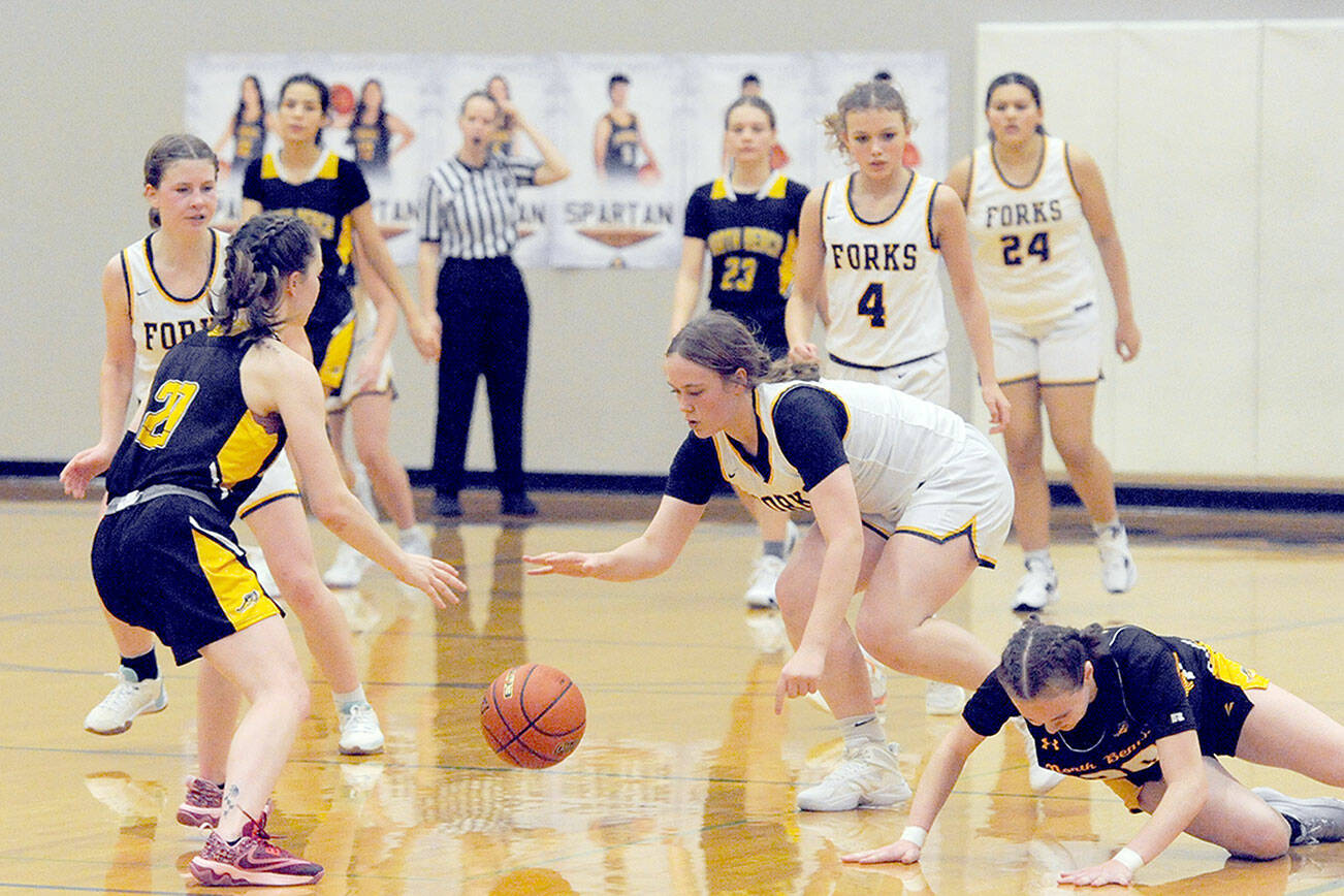 Forks’ Fynlie Peters (right) competes with North Beach for ball control Tuesday evening in the Spartan Gym where Forks defeated the Hyaks 81-12. Also in the action for Forks, from left, are Bailey Johnson, Karee Neal and Kareena Nandial. (Lonnie Archibald/for Peninsula Daily News)