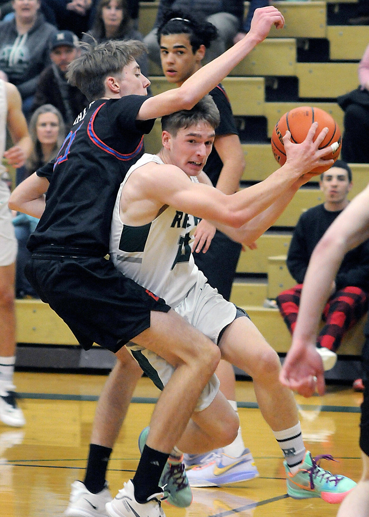 Port Angeles’ Josiah Long, right, tries to escape the defense of East Jefferson’s 6-foot-8 Stuart Dow in a game last year in in Port Angeles. Dow had eight blocks in his first game this year. (Keith Thorpe/Peninsula Daily News)
