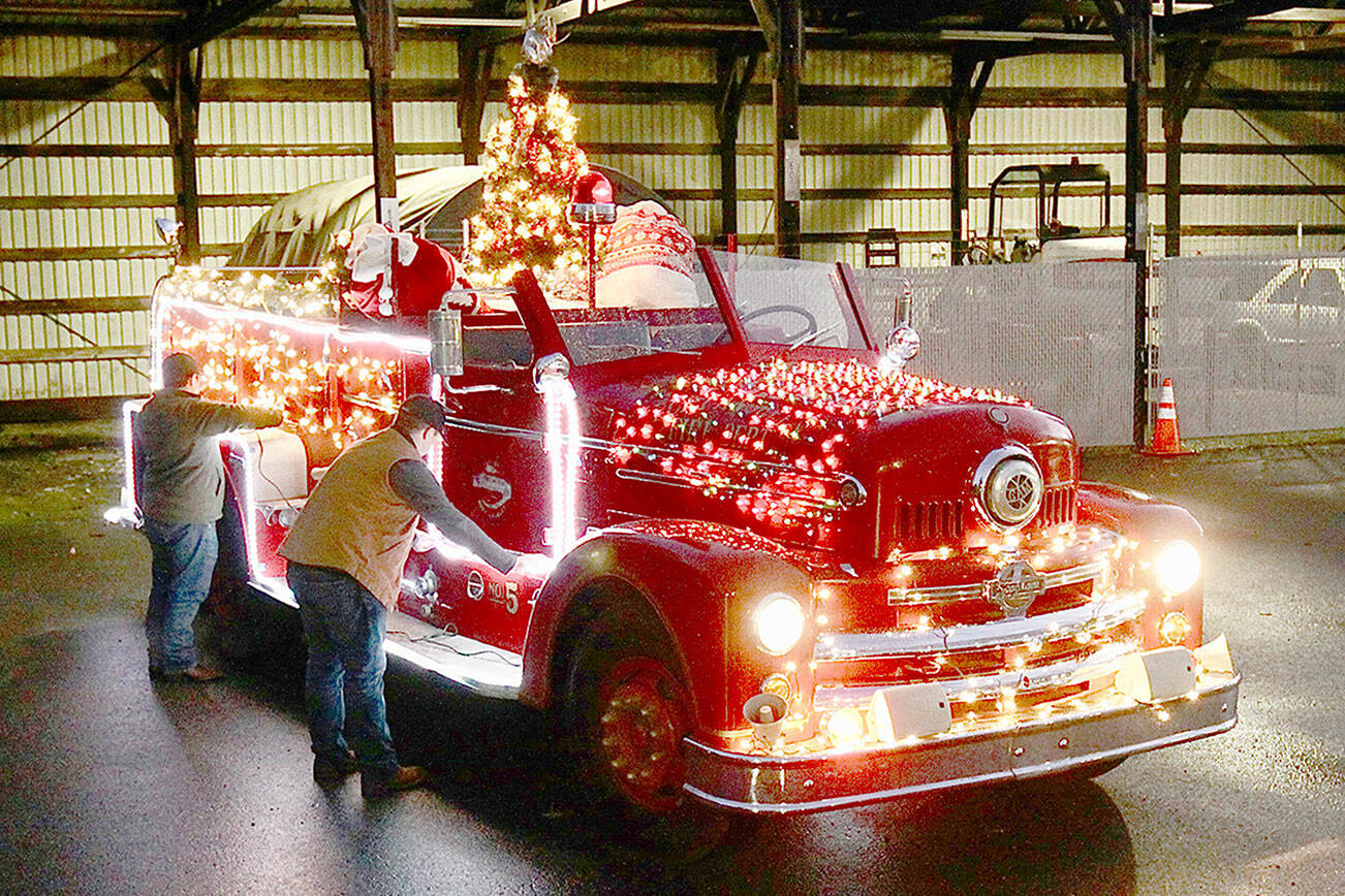 Dave Logan
Tyler Gage and Adam DeFilippo decorate the 1956 Seagrave fire engine in 2022.