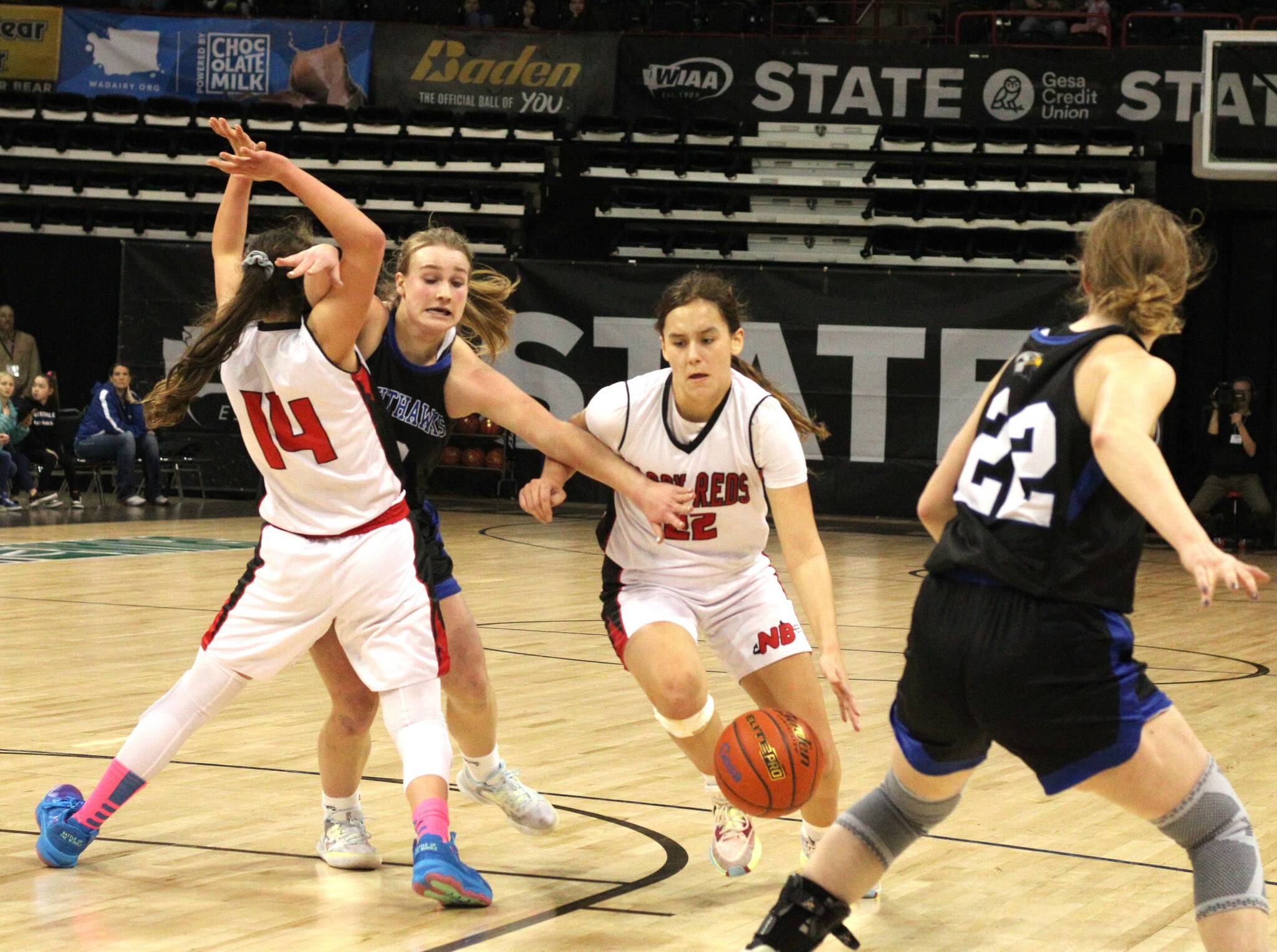 Neah Bay’s Amber Swan drives around a screen set by teammate Cerise Moss (14) during a Class 1B state tournament quarterfinal against Oakesdale at the Spokane Arena last March. (Byrne Bennett/Cheney Free Press)