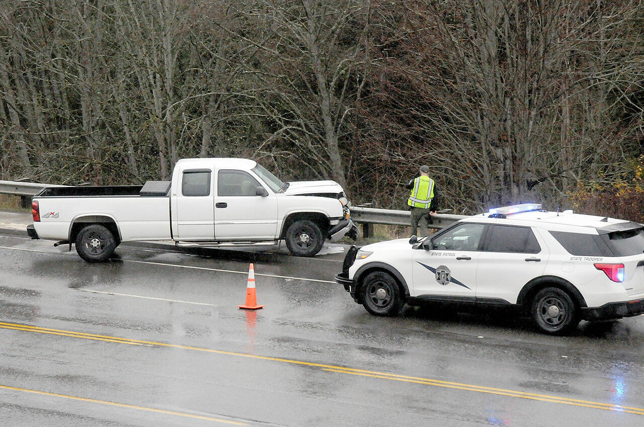 A truck rests against a guardrail on U.S. Highway 101 west of North Brook Avenue at Lees Creek east of Port Angeles on Thursday. (Keith Thorpe/Peninsula Daily News)