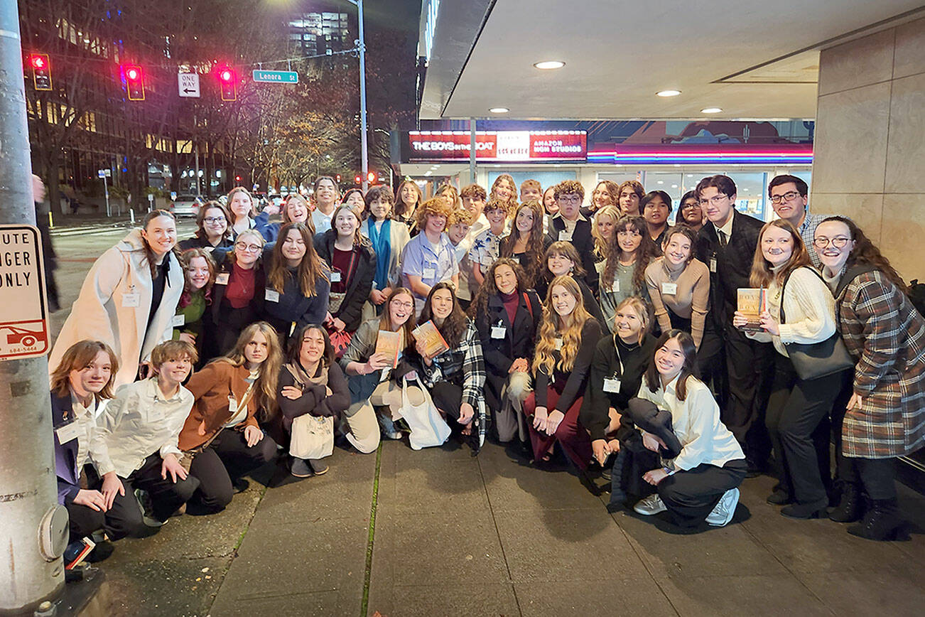Sequim High School Interact Club students pose in front of Seattle's SIFF Cinema Downtown before a screening of  "The Boys in the Boat" on Thursday.