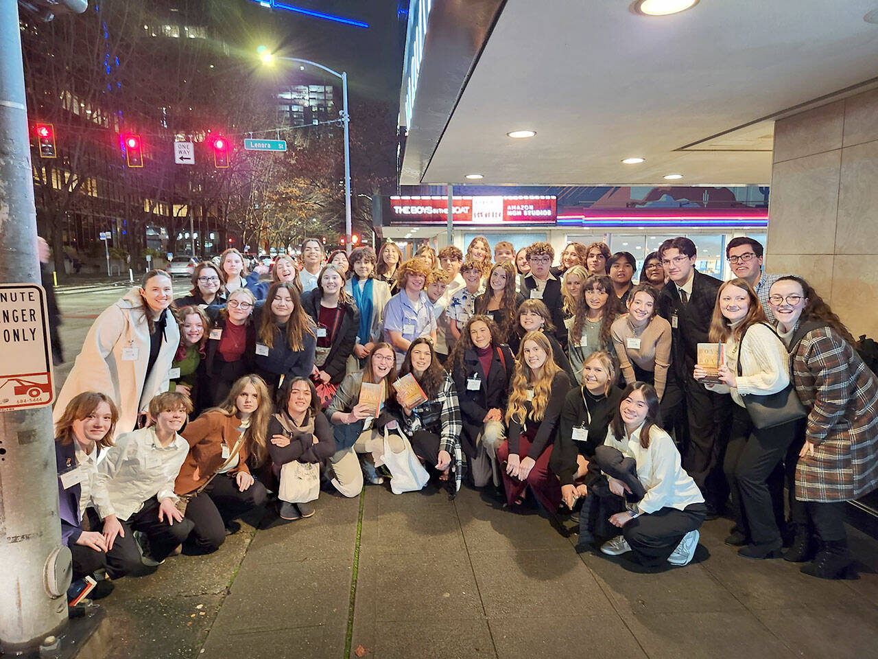 Sequim High School Interact Club students pose in front of Seattle’s SIFF Cinema Downtown before a screening of “The Boys in the Boat” on Thursday.