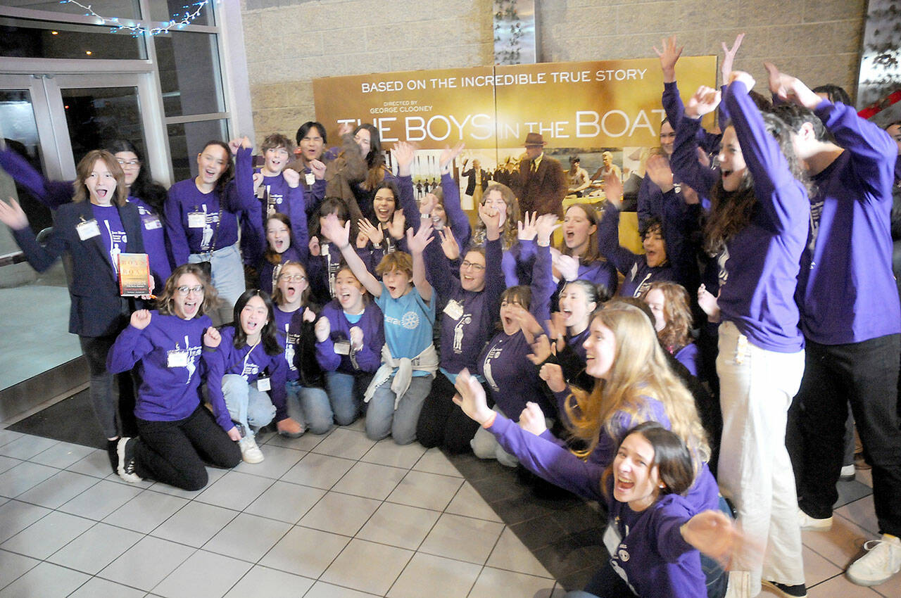 Members of the Sequim High School Interact Club respond to a prompt to show excitement for a television crew following Friday night’s special screening of “The Boys in the Boat” at Deer Park Cinemas in Port Angeles. (Keith Thorpe/Peninsula Daily News)
