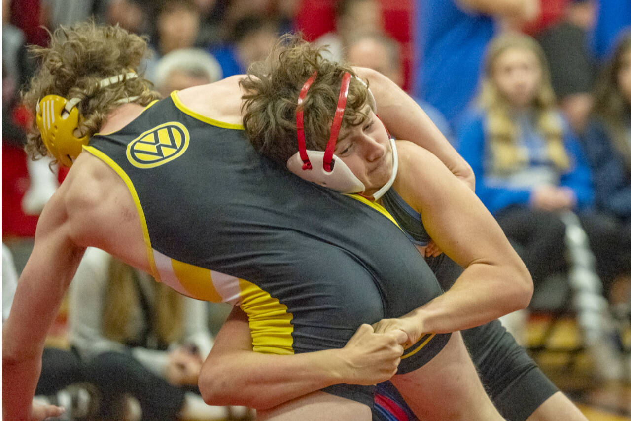 East Jefferson’s Grady White, white ear protectors, takes down Vashon’s Michael Ryland during the East Jefferson Invitational held Saturday at Port Townsend. (Steve Mullensky/for Peninsula Daily News)
