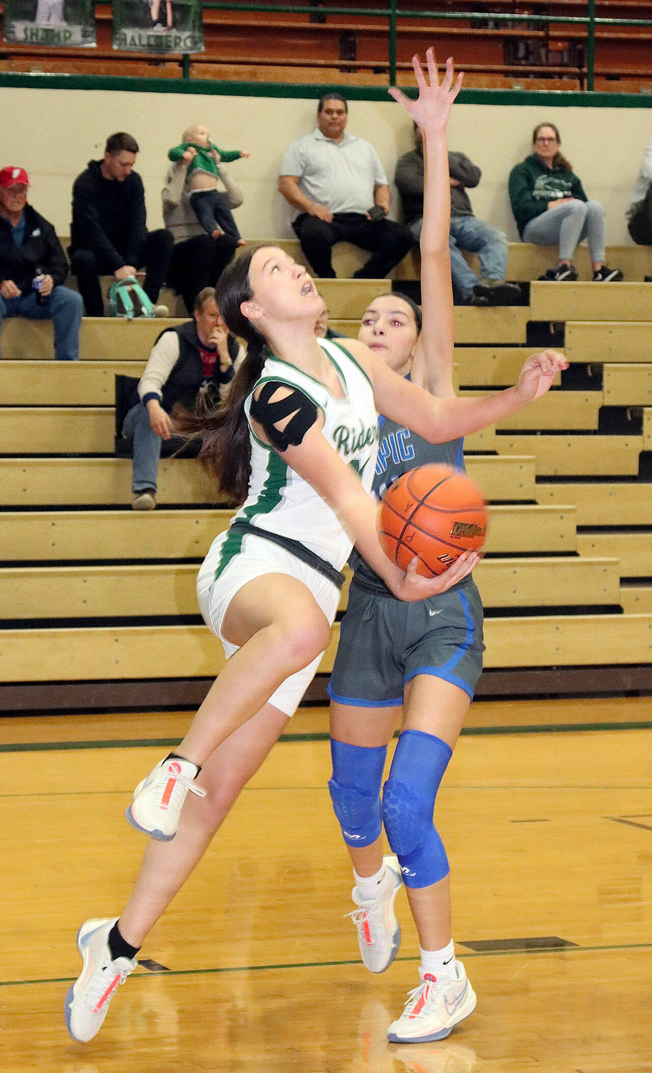 Dave Logan/for Peninsula Daily News Port Angeles’ Lindsay Smith attempts a reverse layup during the Roughriders’ 59-29 win over Olympic on Thursday in the Rider Gymnasium.