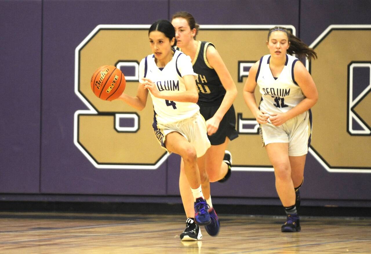 Sequim’s Gracie Chartraw (4) pushes the ball up the court against North Kitsap on Friday night as Hailey Wagner (32) follows the play. Chartraw scored 23 in a 56-40 win. (Michael Dashiell/Olympic Peninsula News Group)