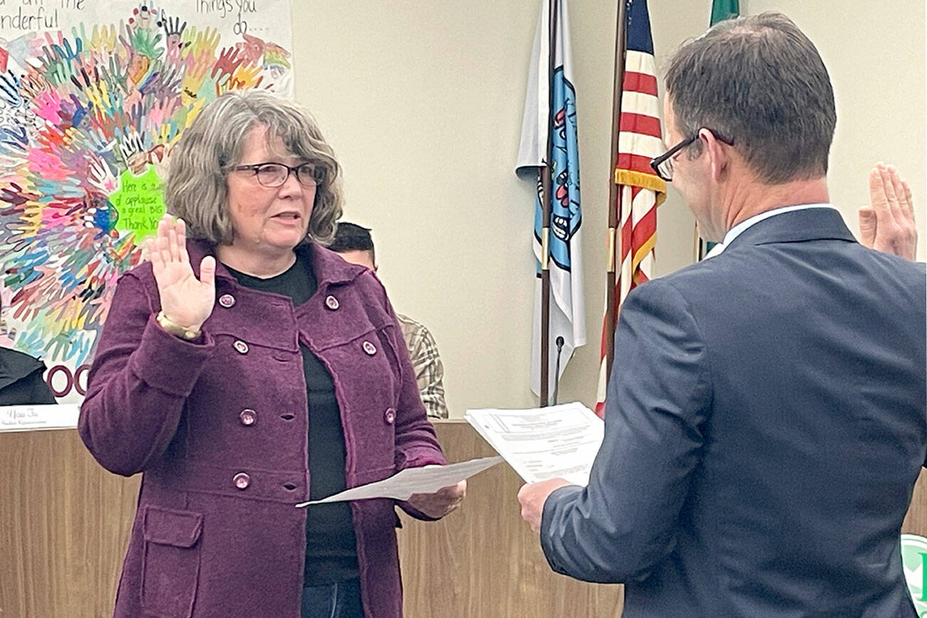 Kirsten Williams, left, was one of three Port Angeles School Board members sworn in by Clallam County Superior Court Judge Simon Barnhart on Dec. 14. Stan Williams (no relation) and Sandy Long also took the oath at the board’s meeting. (Paula Hunt/Peninsula Daily News)