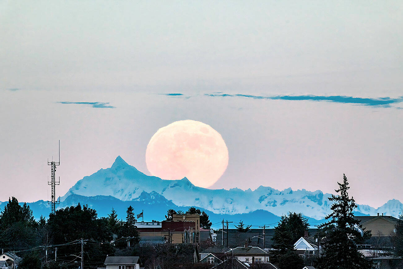 Steve Mullensky/for Peninsula Daily News

The Cold Moon, the December full moon and the last full moon of the year, rises above Mount Shuksan and over homes in Port Townsend's Uptown neighborhood in the early evening Tuesday.