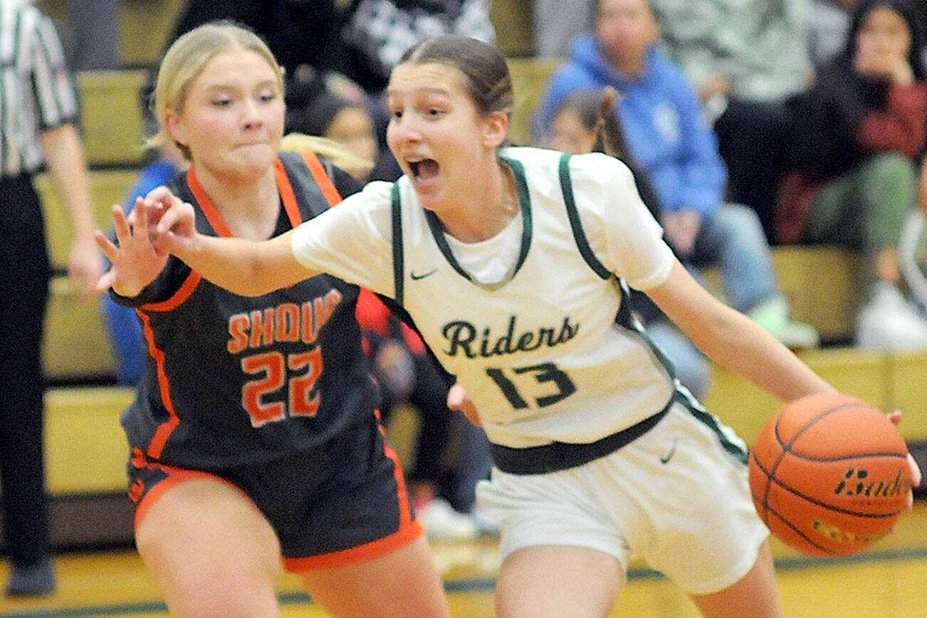 KEITH THORPE/PENINSULA DAILY NEWS
Port Angeles' Morgan Politika, right, charges to the key defended by Washougal's Ireland Albaugh on Thursday at Port Angeles High School.